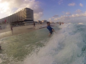 James giving a kung-fu kick to the waves of Cancún