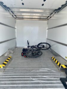 An empty moving van. Empty, that is, save for a single bicycle lying inside.