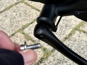 Left rank arm of a bike and the bolt that supposed to be holding it in place.