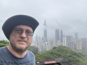 Me, at the top of Xiangshan, Taipei 101 can be seen behind me in the clouds.