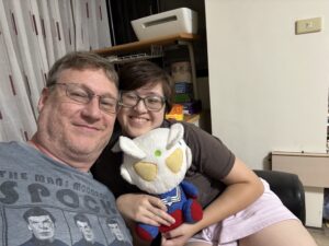 Myself and Melz, on a sofa, with an Ultraman Zero plushy