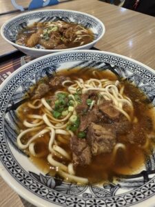 Two bowls of beef noodle soup